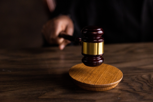 a gavel sitting on top of a wooden table