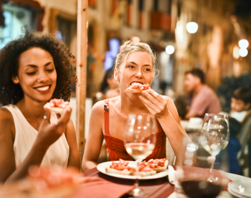 a group of people sitting at a table in a restaurant